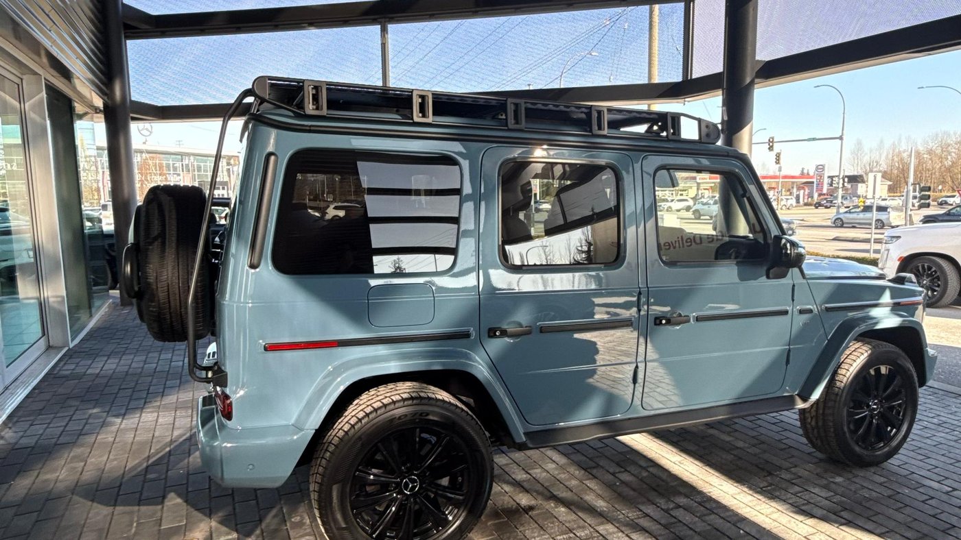 Side profile of 2024 G-Class G-Wagon rental with roof rack and rear ladder