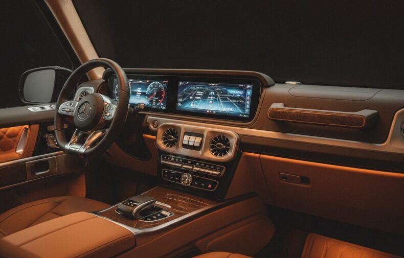 Mercedes G-Class cockpit with dual MBUX displays and ambient lighting