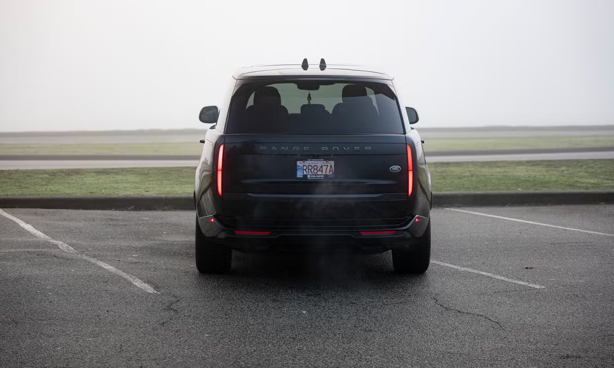 Rear view of a black Range Rover with taillights on, North Vancouver